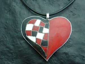 großes Herz mit Karomuster, Emailfarben: Schwarz, Weiß und Rot, Fassung in Feinsilber